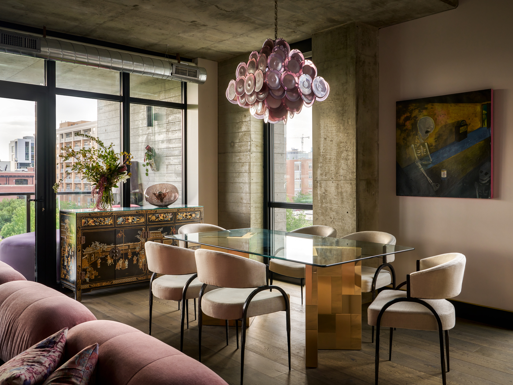 Retouched dining area photography with balanced exposure, highlighting the statement chandelier and overall space design.