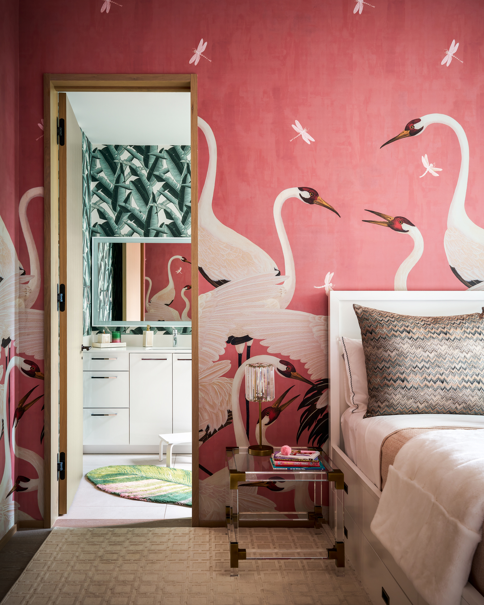 Playful kids' bedroom with bold wallpaper and an adjoining bathroom visible. Perspective correction in retouching straightens the lines of the room and ensures a professional, balanced image.